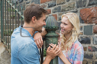 Hip young couple standing by railings