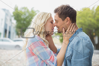 Hip young couple about to kiss