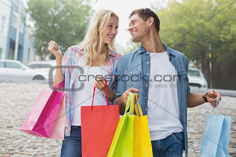 Hip young couple on shopping trip
