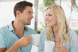 Hip young couple having coffee together