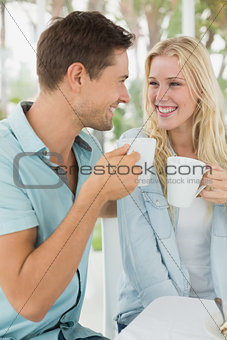 Hip young couple having coffee together