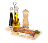 Grilled salmon with lemon and herbs on cutting board