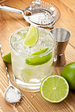 Classic margarita cocktail with salty rim on wooden table