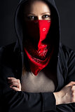 girl in black hood with a red shawl on his face