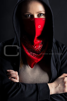 girl in black hood with a red shawl on his face