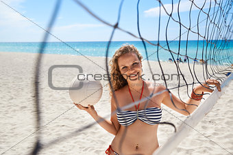 Portrait of woman with volleyball playing beach volley