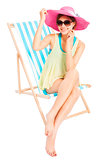 young sunshine girl smiling and sitting on a beach chair