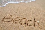 Beach word written on the sandy beach