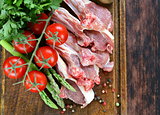 raw meat, lamb chops with vegetables on wooden board