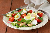 fresh green salad with salmon and tomatoes