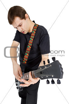 Young man with electric guitar isolated on white background. Per