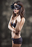 Woman in lingerie wearing a mask