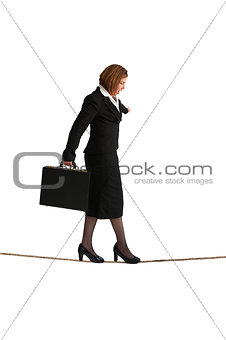 businesswoman balancing on a tightrope