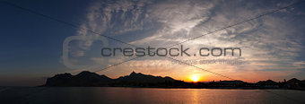 Sea sunset on background of mountains