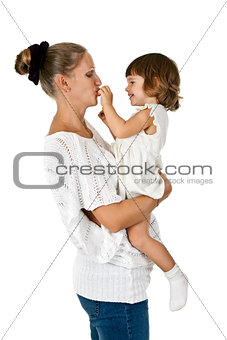 little girl at the hands of the mother feeds her and plum