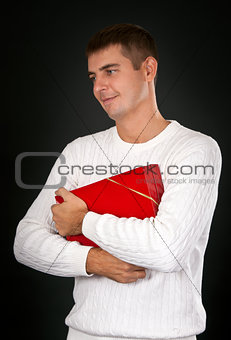 sad man with a red gift box in a studio