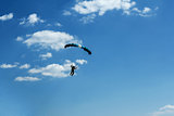 unidentified skydiver on blue sky