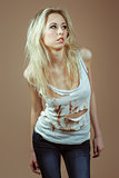Very Expressive blonde girl in a white torn top and jeans