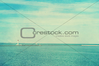 Vintage photo of lighthouse tower. Nautical texture background.
