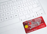 Shopping trolley and credit card on the keyboard