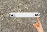 Human hand indicates the search bar in browser