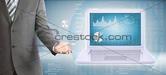 Businessman standing with open laptop