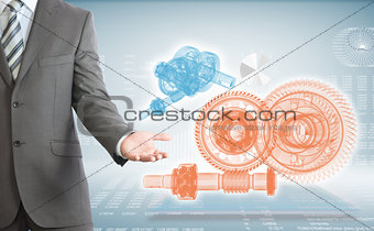 Businessman points hand on wire frame gears