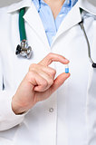 Doctor holding a blue a pill