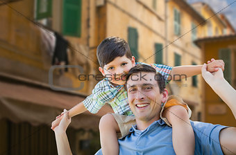Father and Son Playing Piggyback on Streets of France