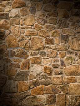 Masonry rock wall lit diagonally