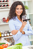 Woman Drinking Red Wine in Home Kitchen