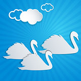 White paper swans and clouds