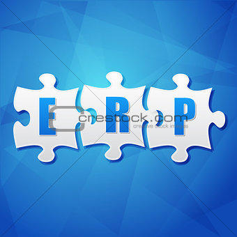 ERP in puzzle pieces over blue background, flat design
