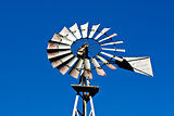 Western metal windmill on sky