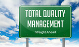 Total Quality Management on Green Highway Signpost.