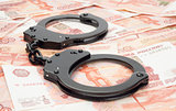 financial crime. Steel handcuffs and money