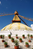 Stupa with buddha eyes and prayer flags on clear blue sky