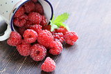 juicy ripe red berry raspberries on wooden background