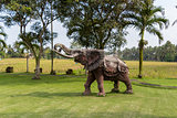 Elephant statue standing on a lawn at a park