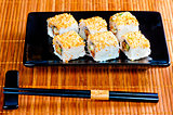 rolls with eel and sesame seeds on a beautiful dish