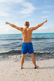Man in blue swim shorts in the beach