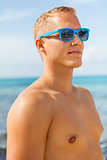 Man in blue swim shorts in the beach