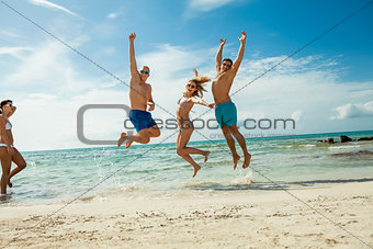 young happy friends havin fun on the beach