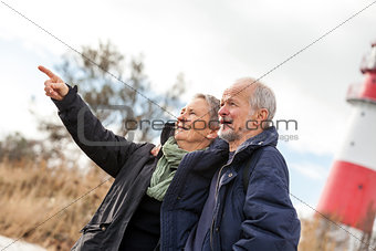 happy mature couple relaxing baltic sea dunes 