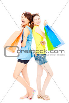 happy and smiling  young women with shopping bags