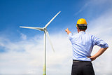  young engineer standing and point to wind generator 