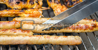 Sausages and chicken wings on smoking grill barbeque