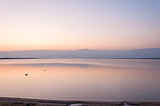 Sunrise over Jordan mountain Dead Sea reflection on water Israel