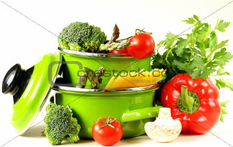 green pots full of vegetables (tomatoes, asparagus, mushrooms, broccoli) and pasta