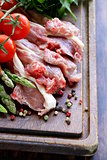 raw meat, lamb chops with vegetables on wooden board